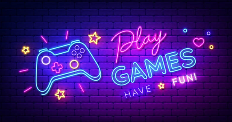 Neon sign saying Play GAMES HAVE FUN! with a game controller and stars on a brick wall